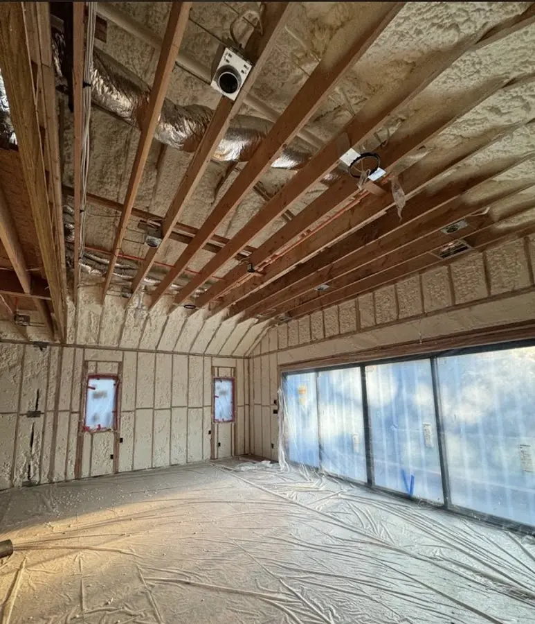 Interior walls and ceiling insulated with spray foam during new construction in Olympia Heights